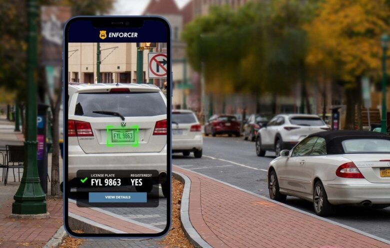 Mobile app scanning a car license plate on a busy street, illustrating the best apps to check license plates in Nigeria
